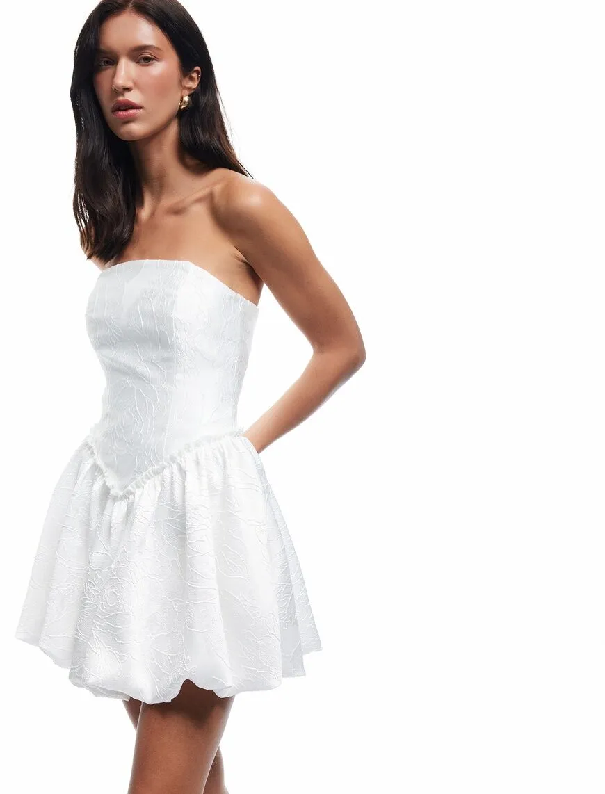 Model side pose white strapless dress